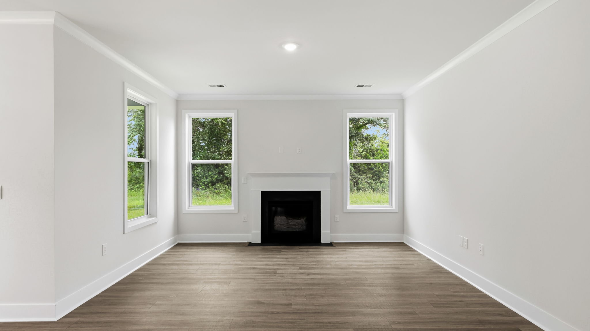 Open living room area with large windows and gas fireplace