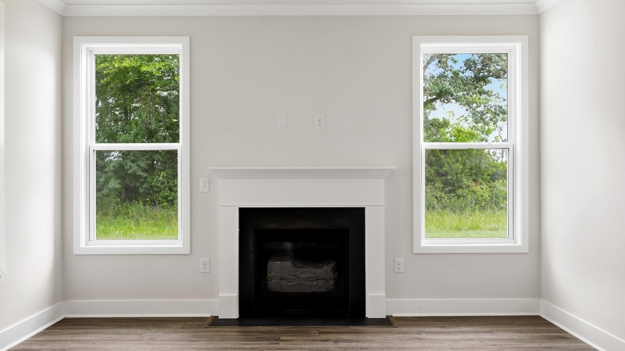 Open living room area with large windows and gas fireplace