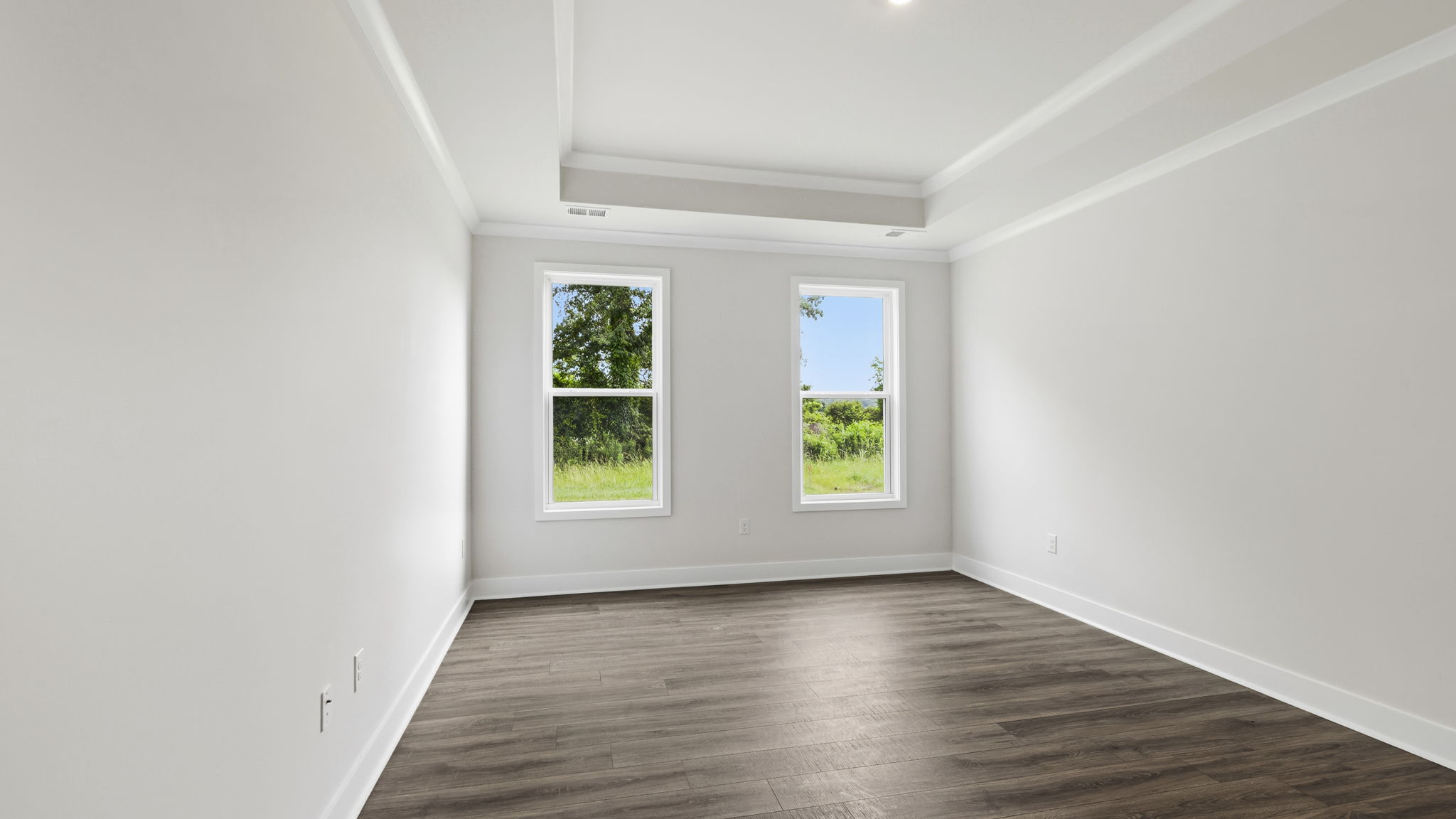 Primary bedroom with large windows