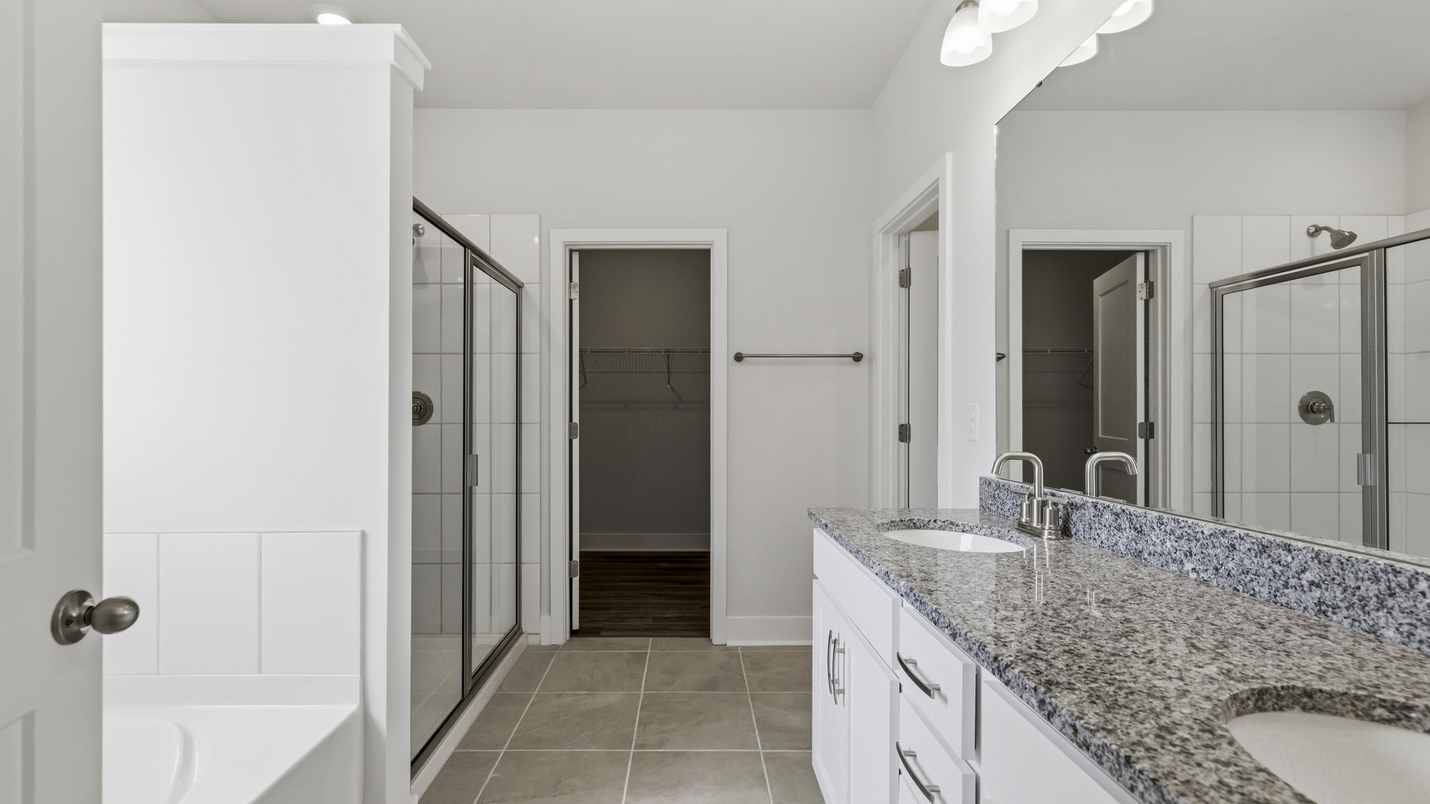 Primary bathroom with dual vanity and walk in shower