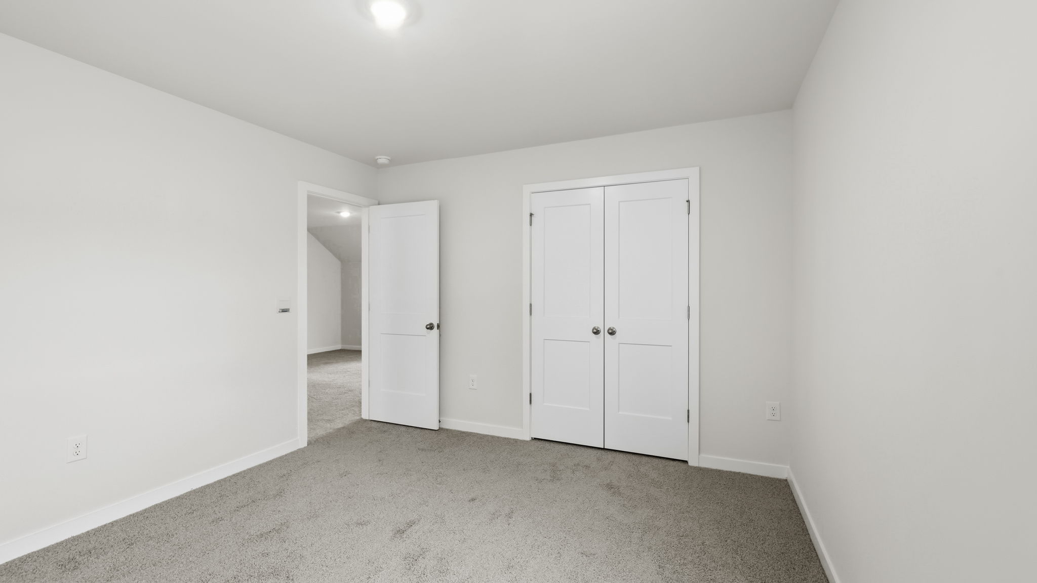 Carpeted bedroom with closet