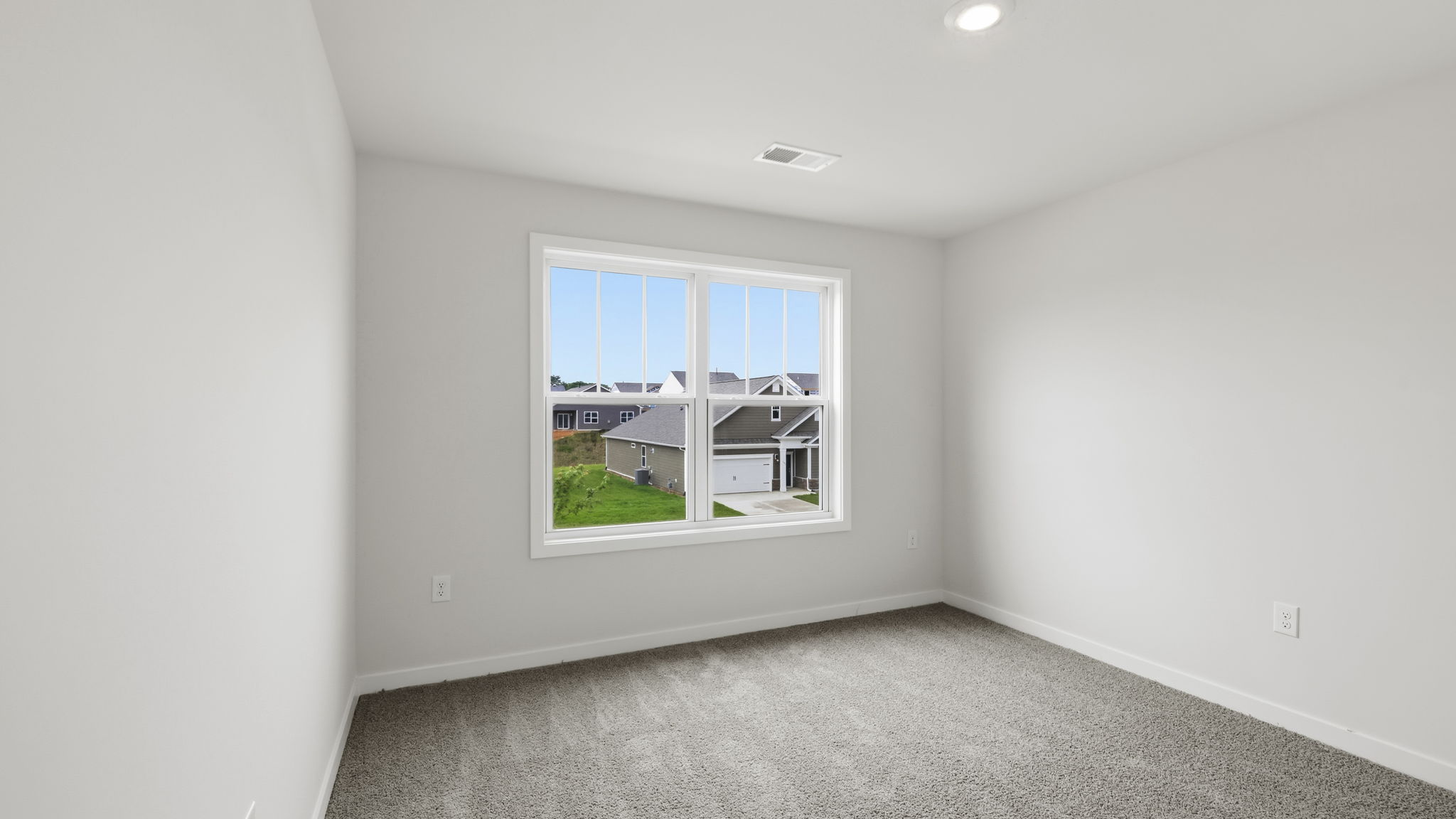 Carpeted bedroom with large window