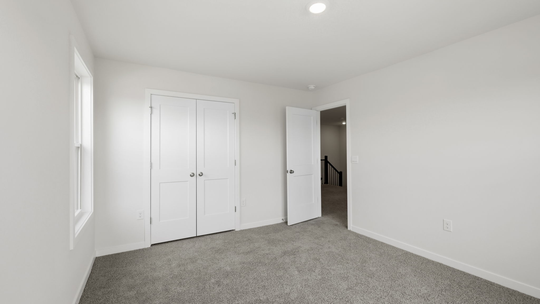Carpeted bedroom with closet
