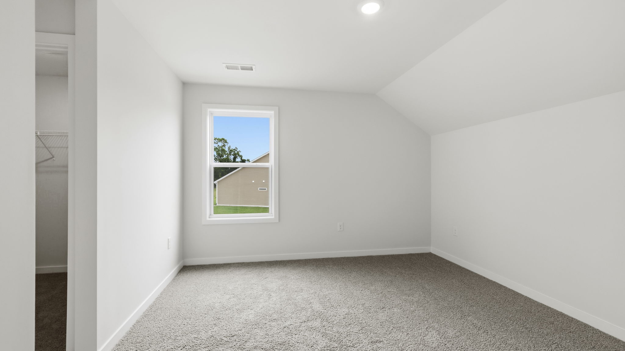 Carpeted bedroom with large window