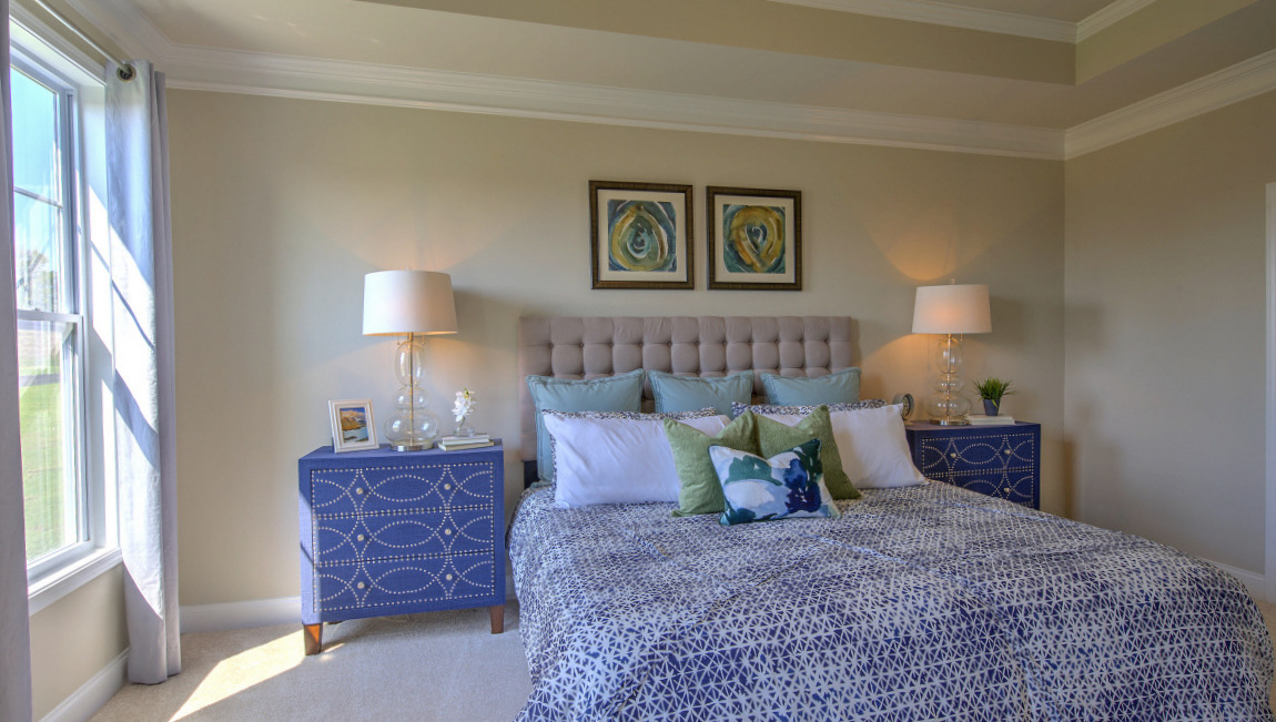 Carpeted primary bedroom with windows