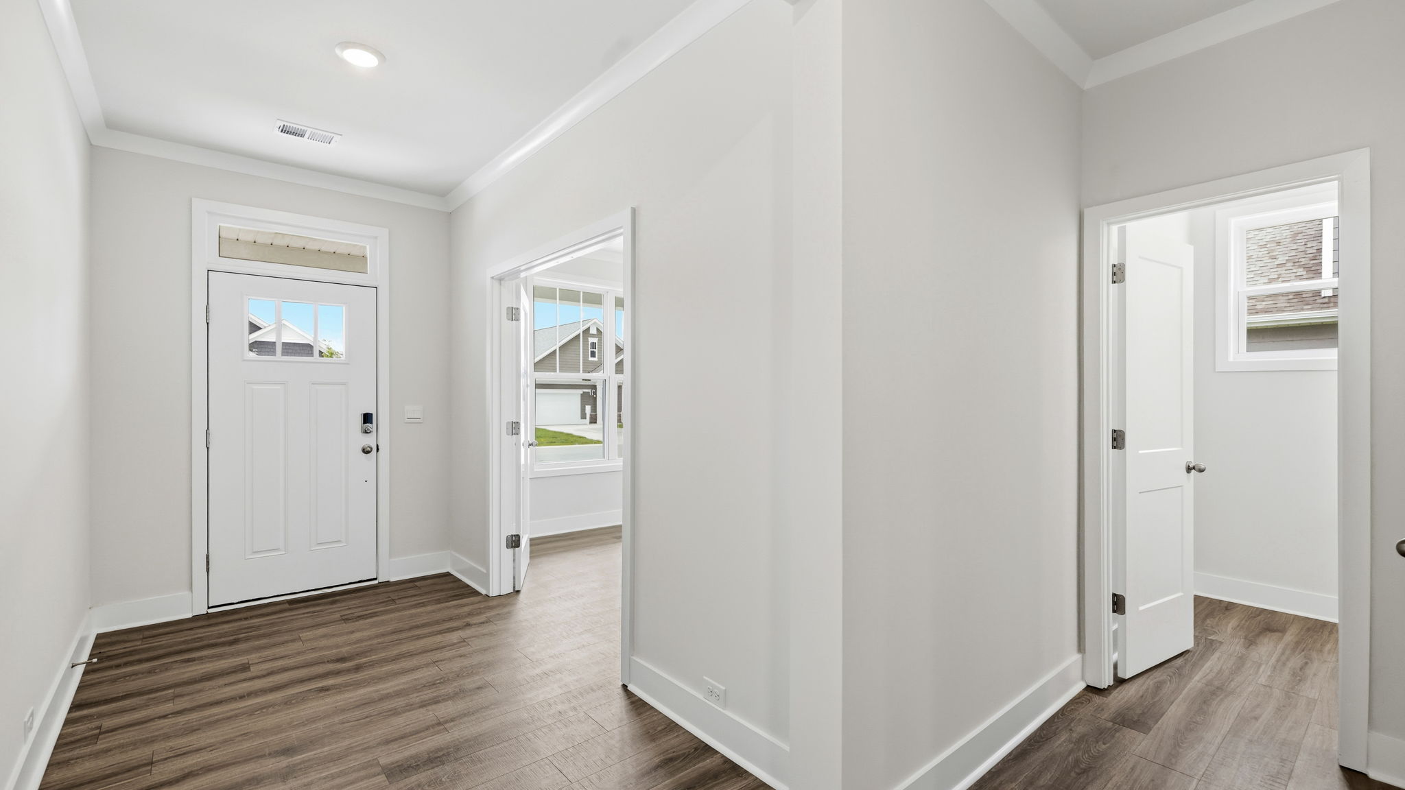Hallway with view of interior front door, office and hall