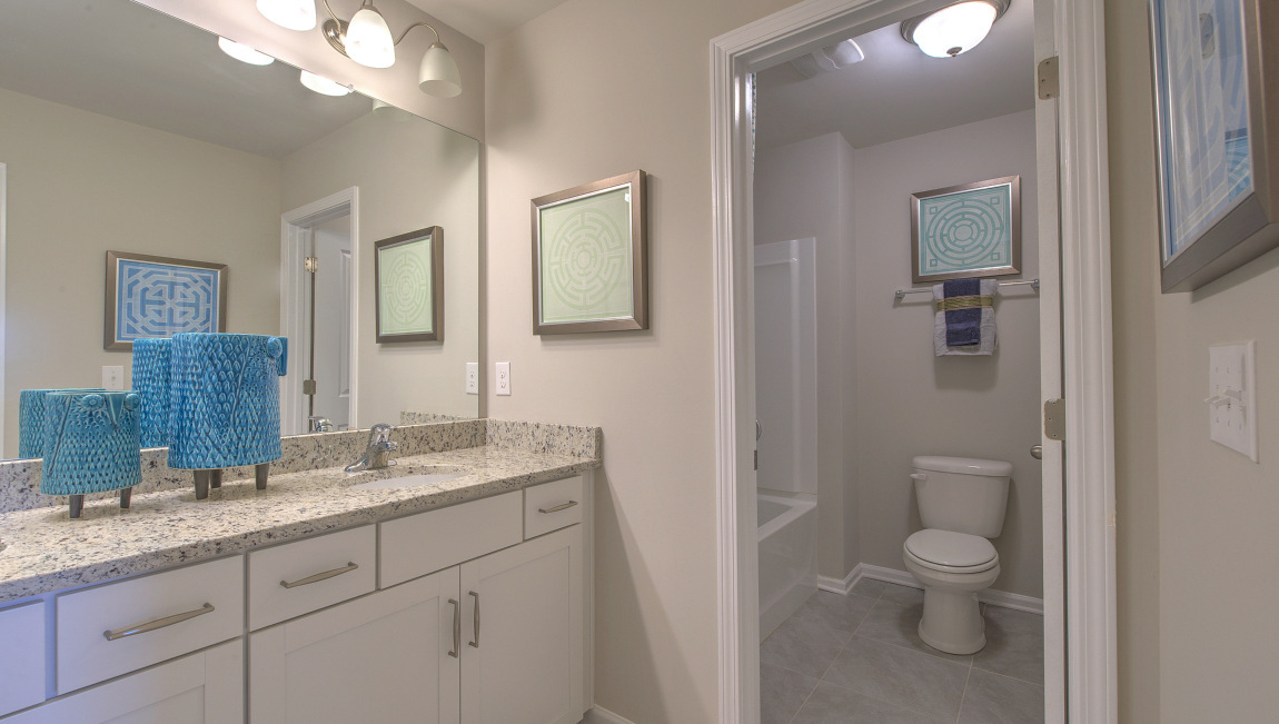 Bathroom with double vanity and toilet closet
