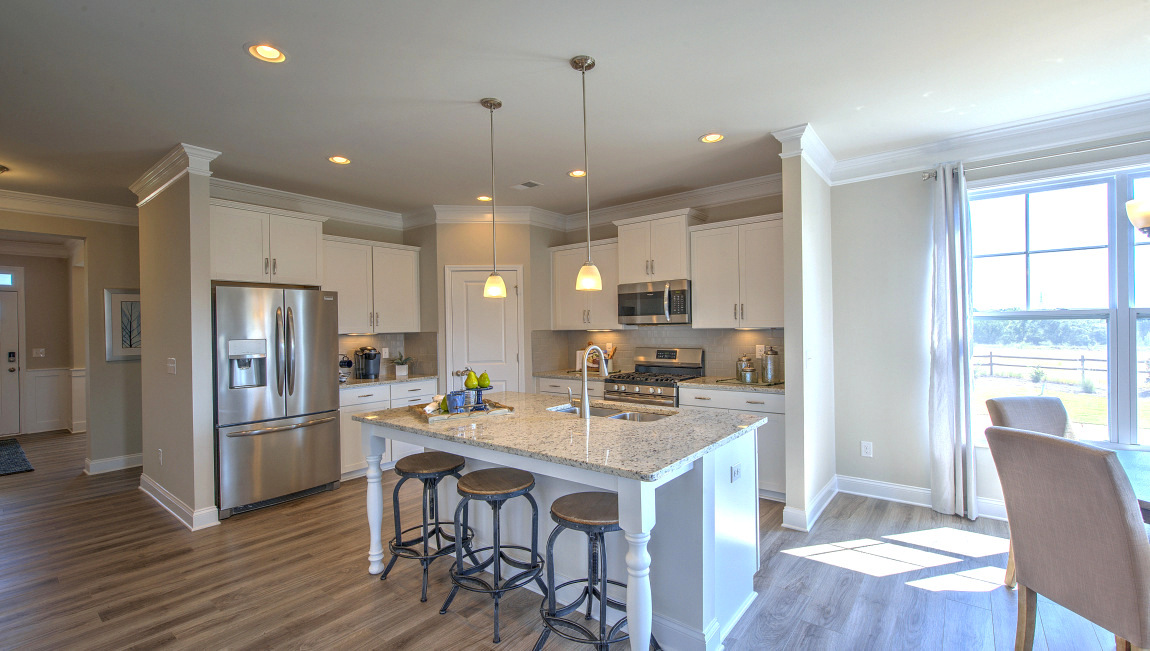 Open concept kitchen with island and stainless steel appliances