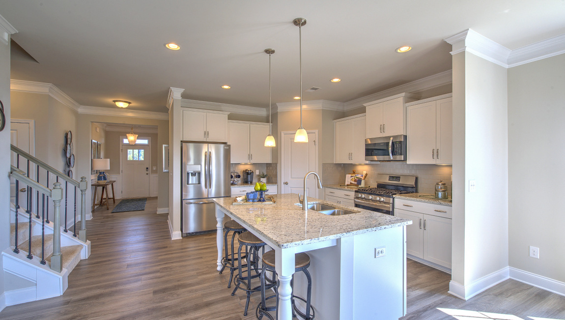Open concept kitchen with island and stainless steel appliances