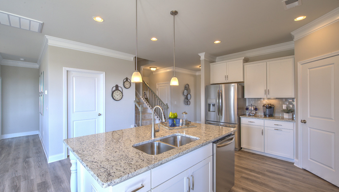 Open concept kitchen with island and stainless steel appliances