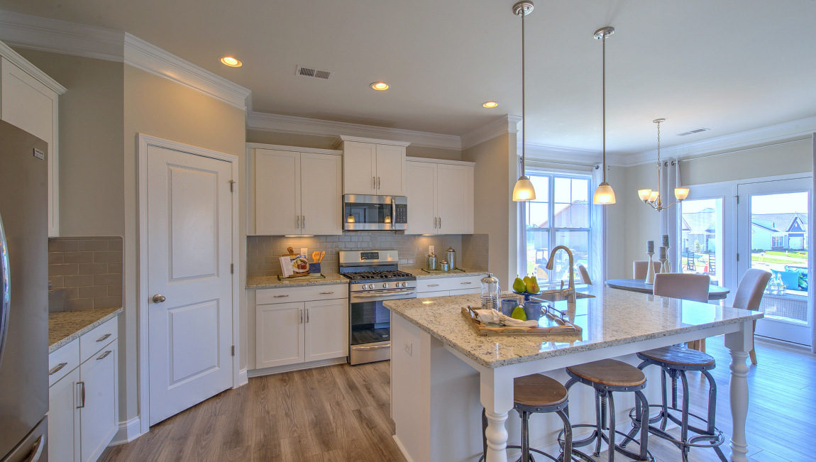 Open concept kitchen with island and stainless steel appliances