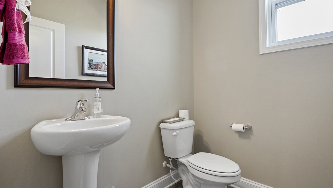 Half bathroom with a single sink and toilet.