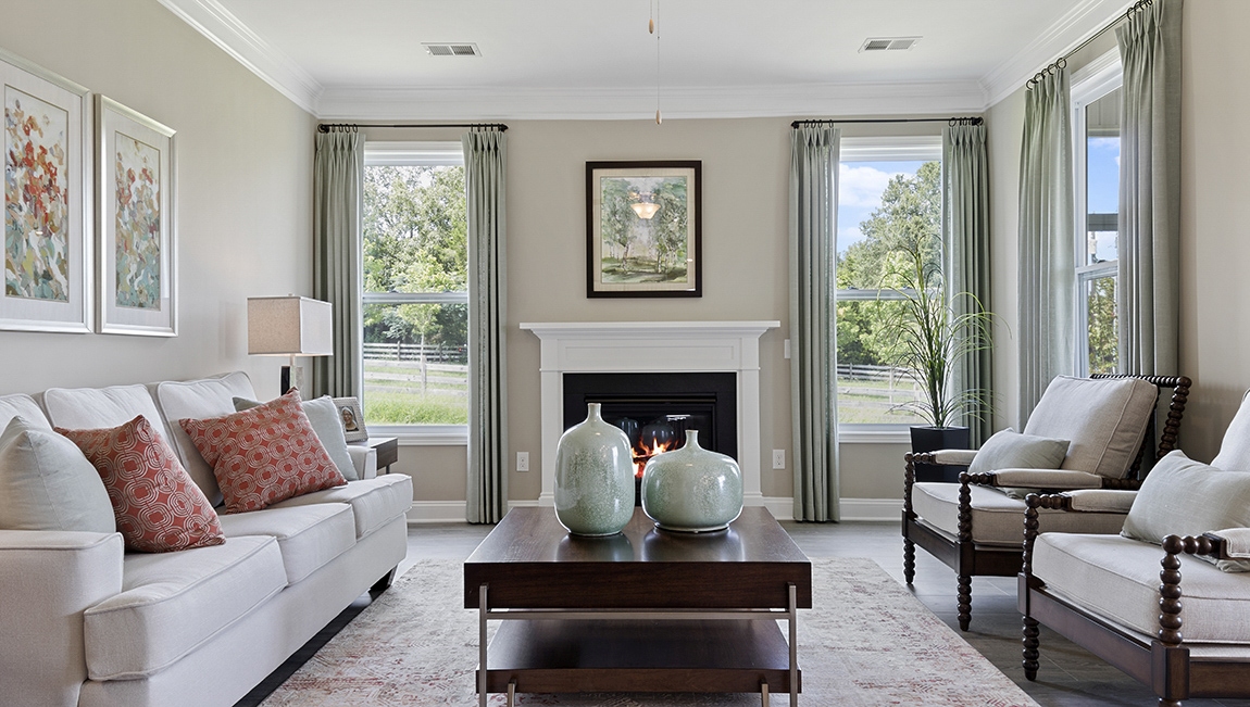 Living room with several large windows for natural lighting.