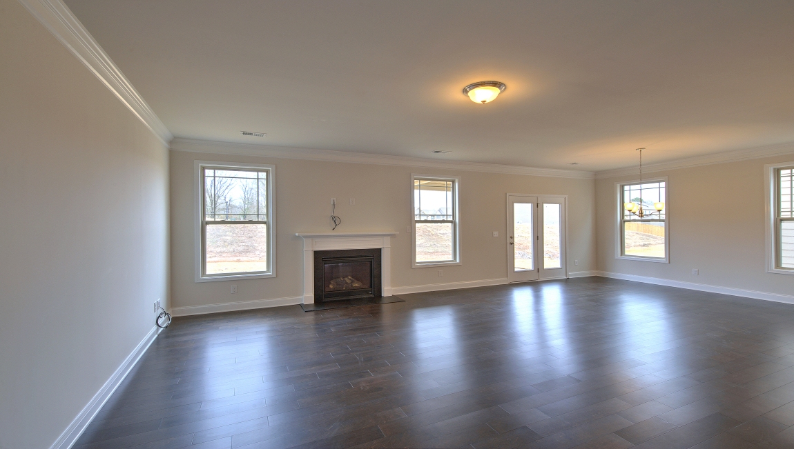 Open living room with large windows and gas fireplace