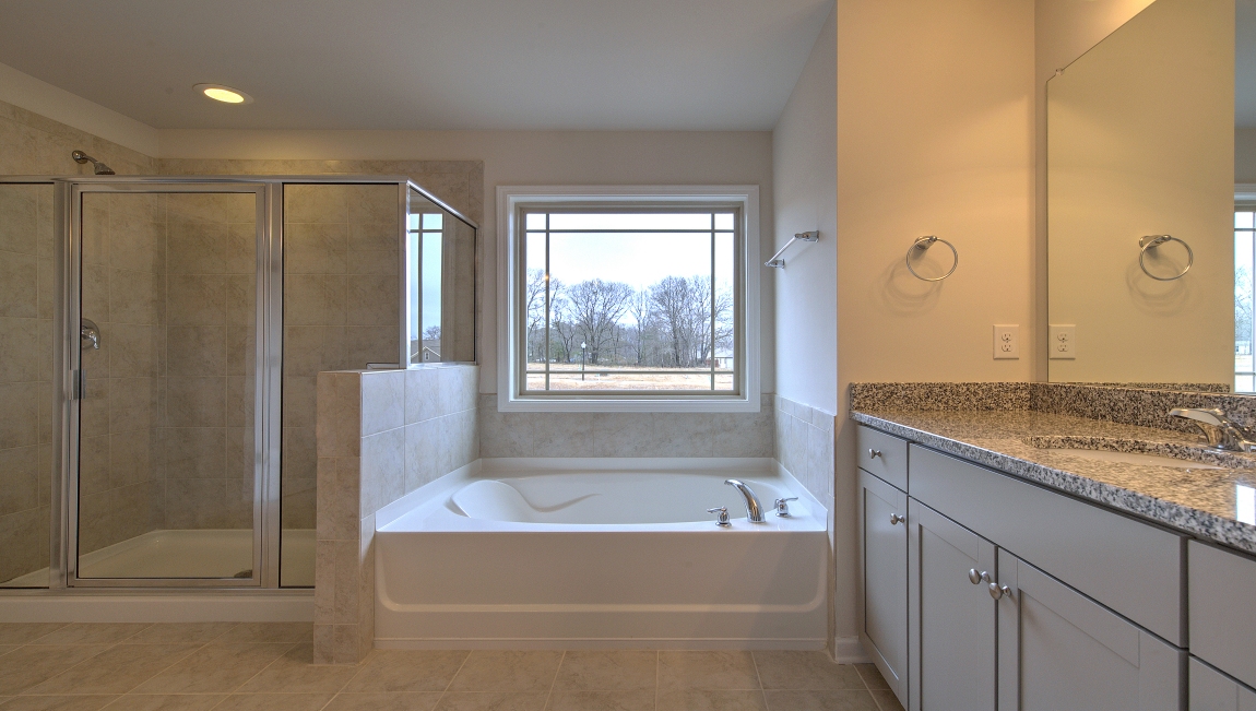 Primary bathroom with dual vanity, garden tub and walk in shower