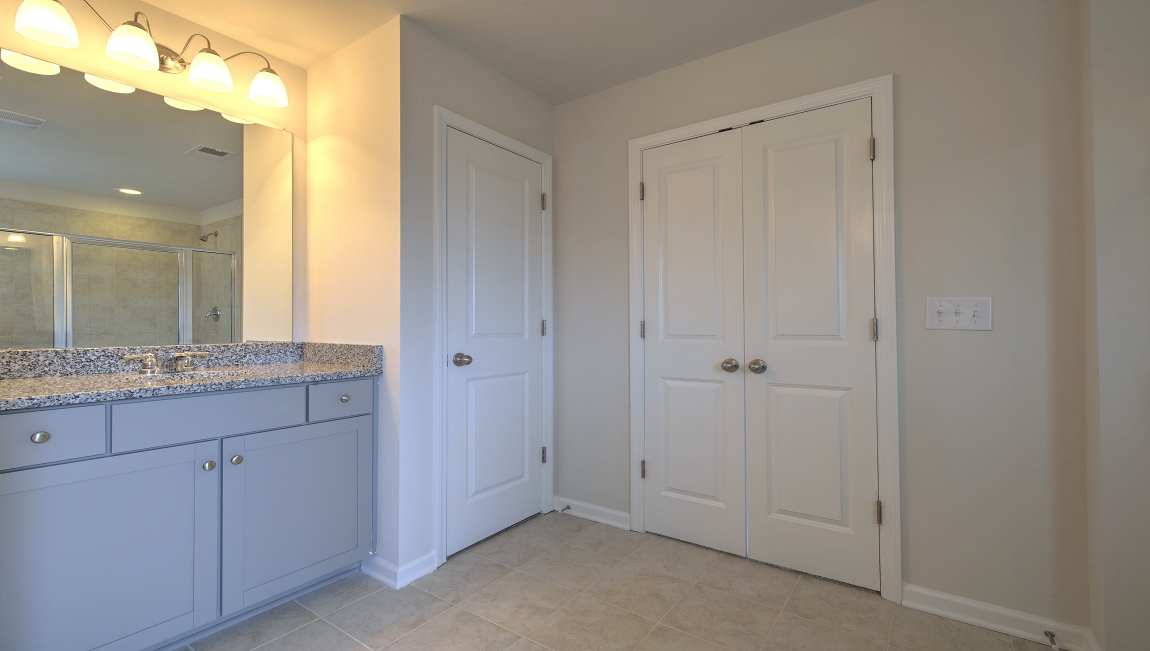 Primary bathroom with dual vanity, garden tub and walk in shower