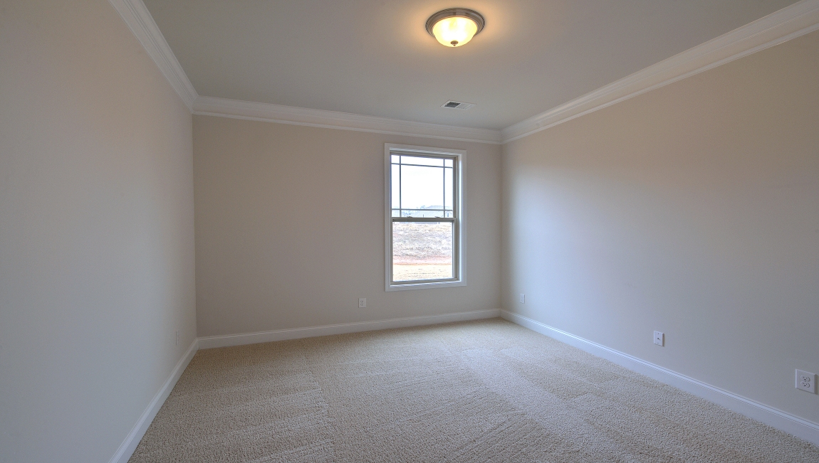 Carpeted bedroom with window