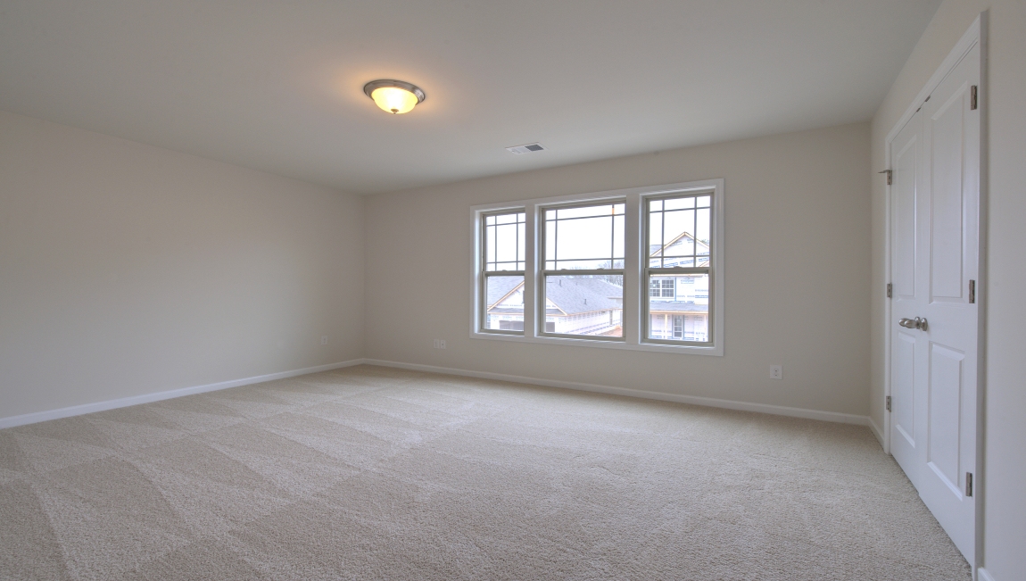 Carpeted bedroom with window