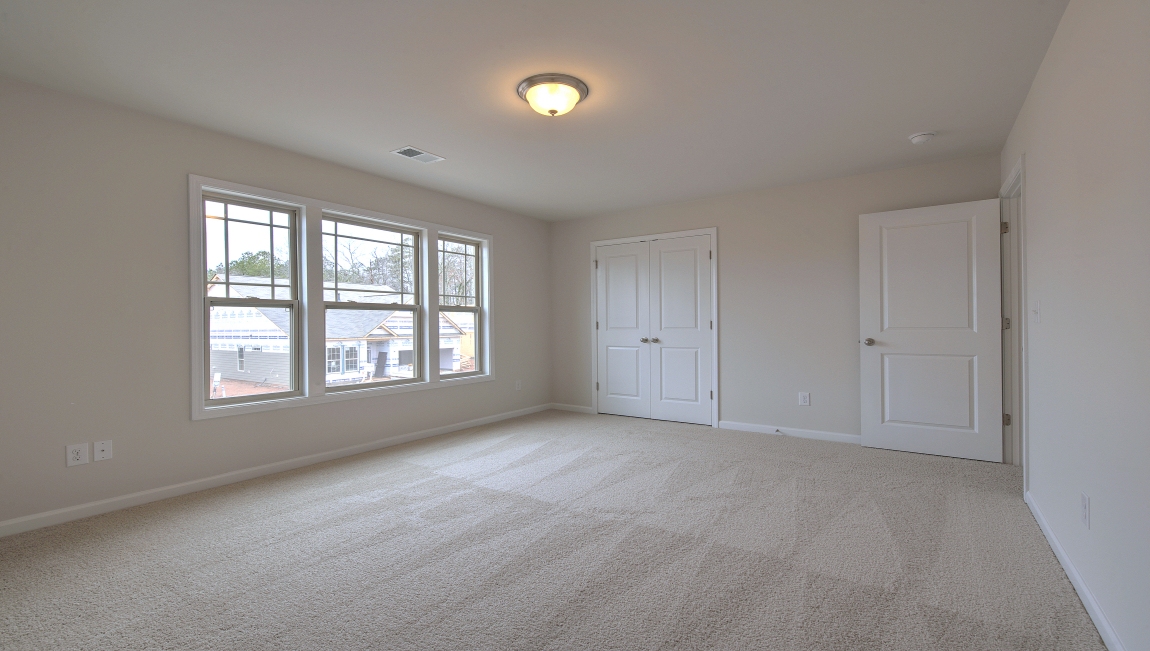 Carpeted bedroom with window