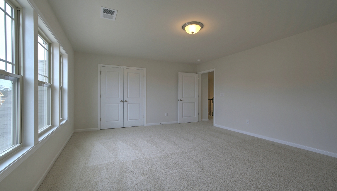 Carpeted bedroom with window