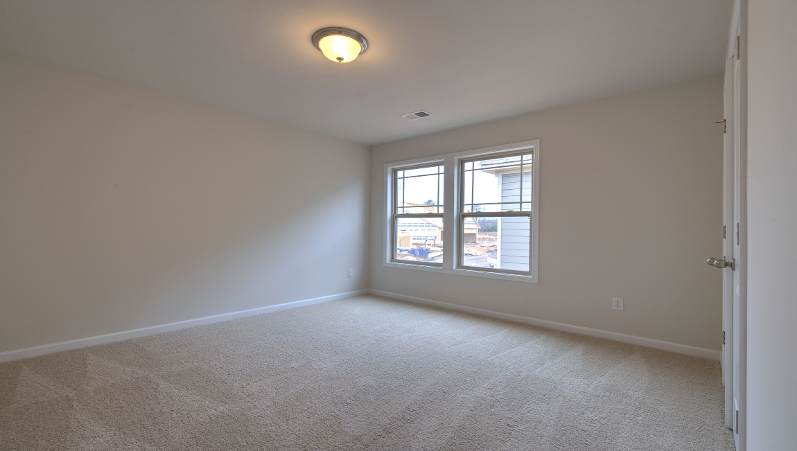 Carpeted bedroom with window