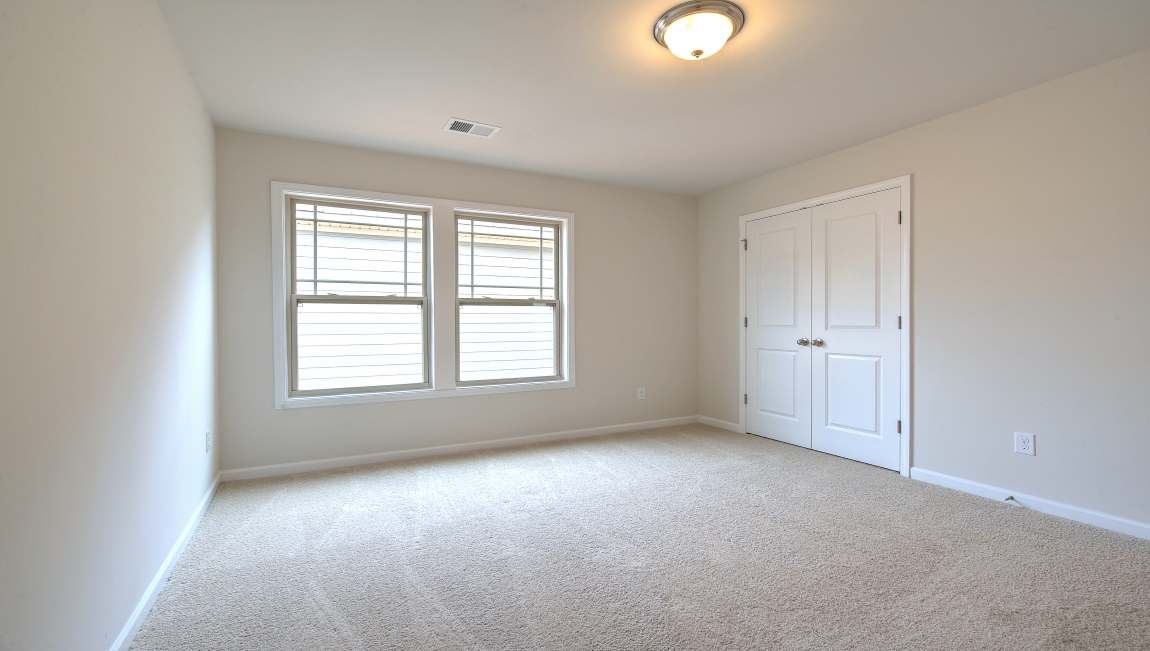 Carpeted bedroom with window