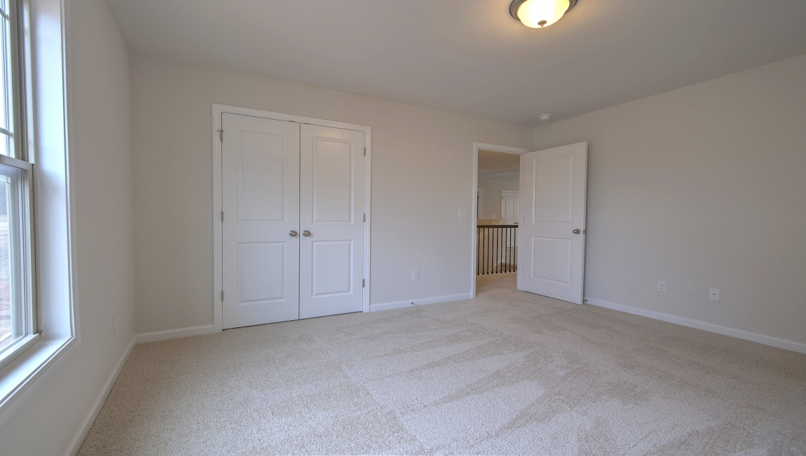 Carpeted bedroom with window