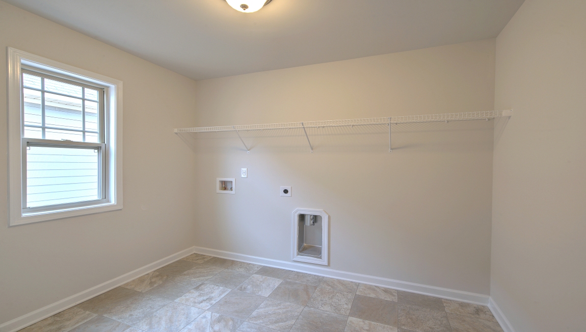 Carpeted rec room with windows