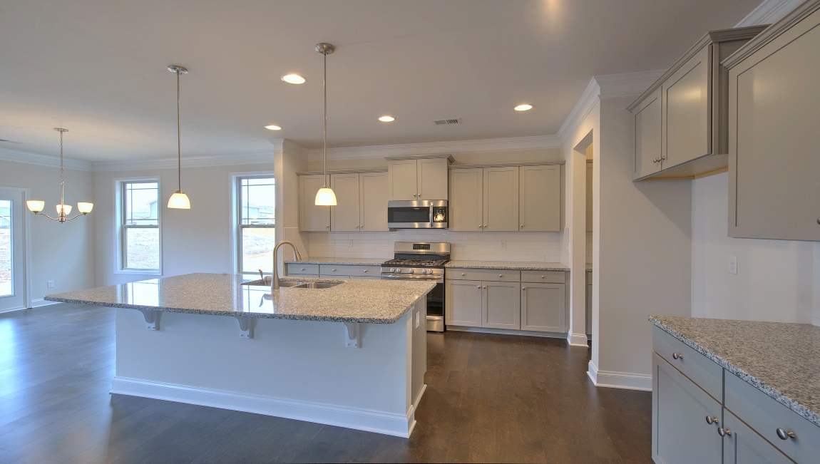 Open kitchen with large island and stainless steel appliances