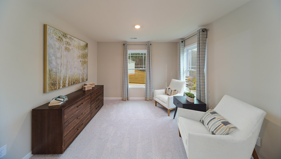 Primary bedroom sitting room, carpeted, two small windows