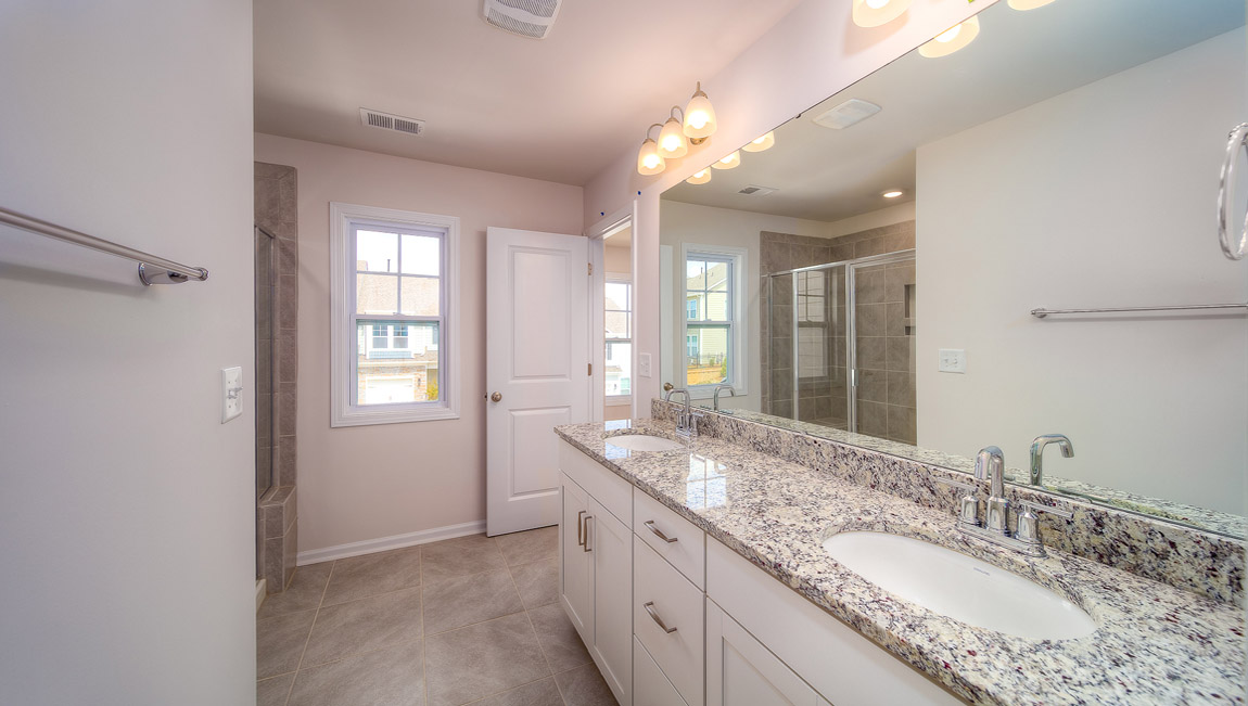 Primary bathroom with dual vanity and shower
