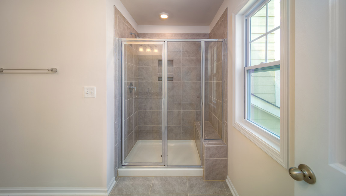 Primary bathroom with dual vanity and shower