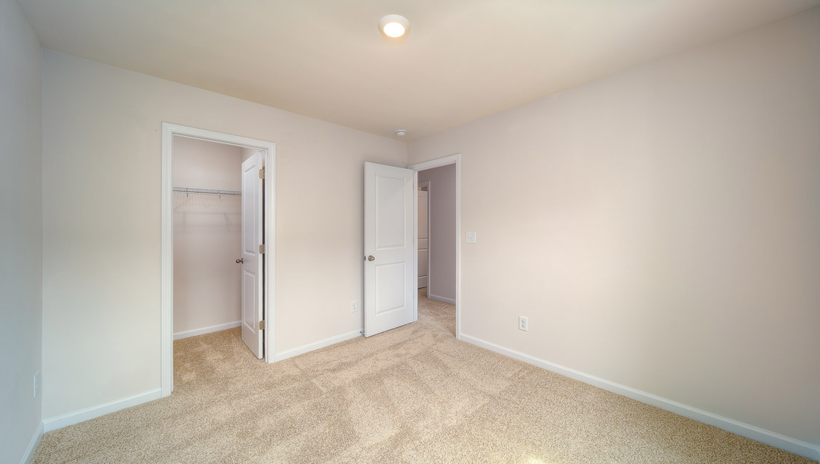 Carpeted bedroom with large windows