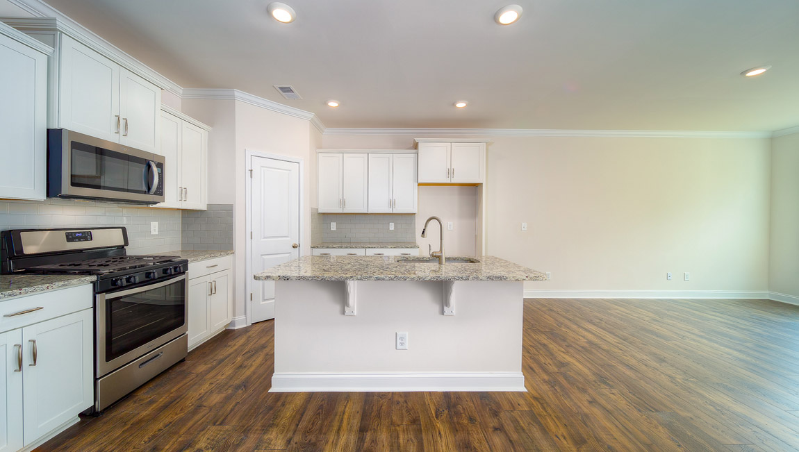 Open kitchen with stainless steel appliances and island