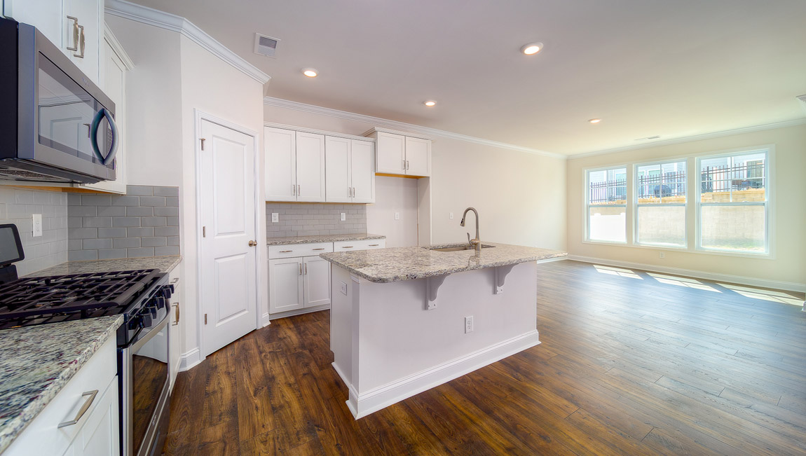 Open kitchen with stainless steel appliances and island