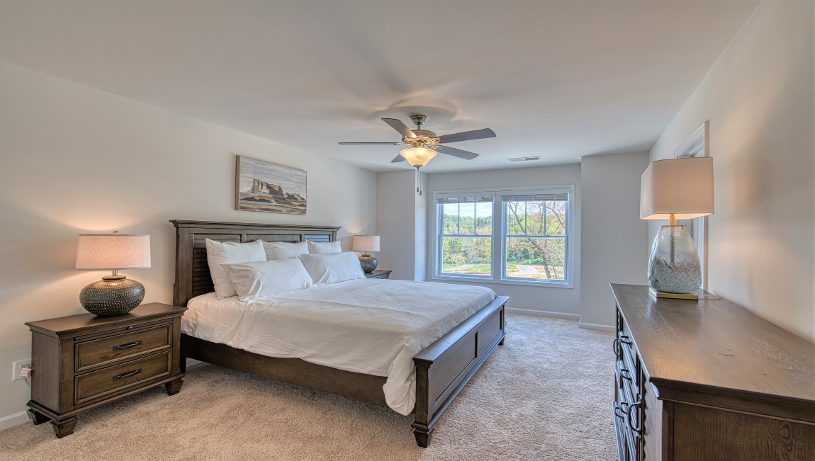 Primary bedroom with large windows