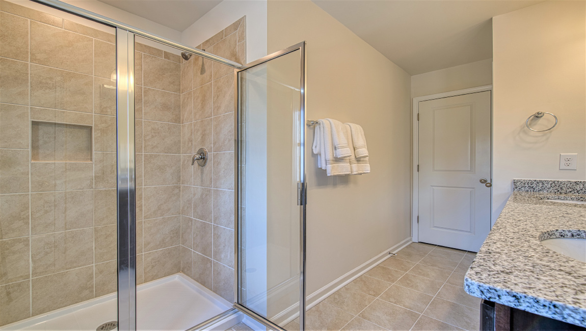 Primary bathroom with walk in shower, glass doors