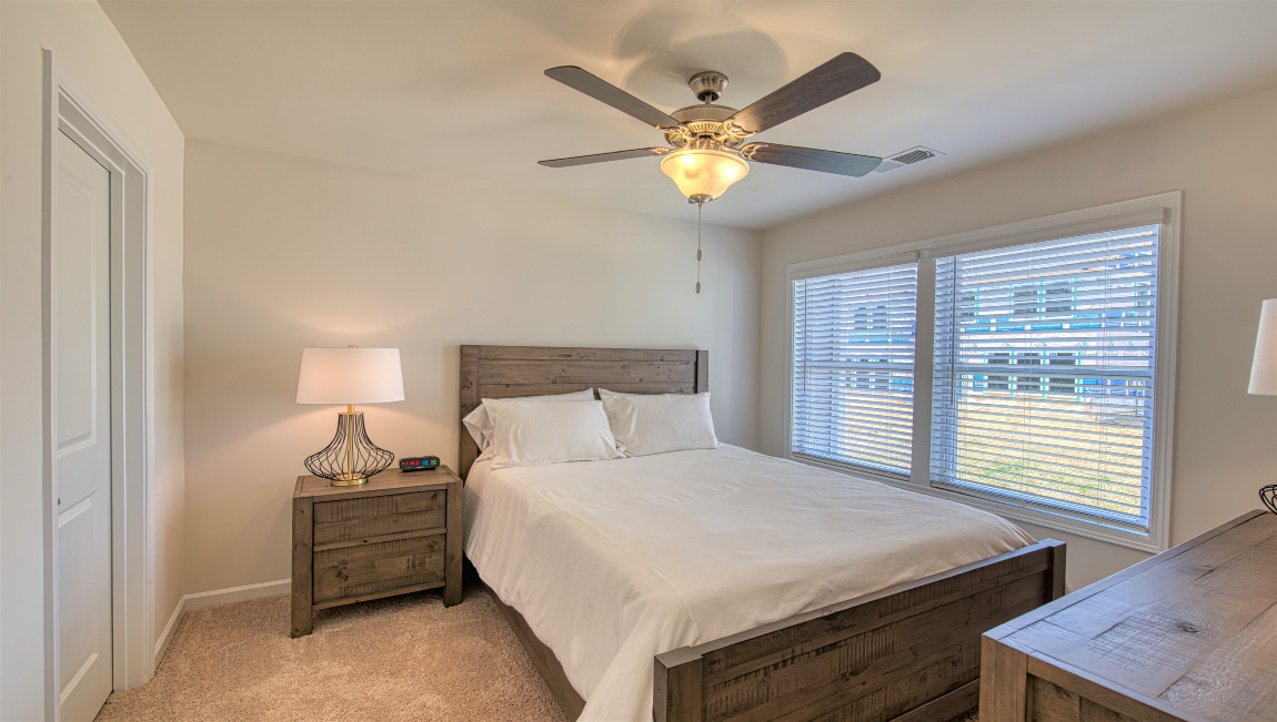 Carpeted bedroom with large window