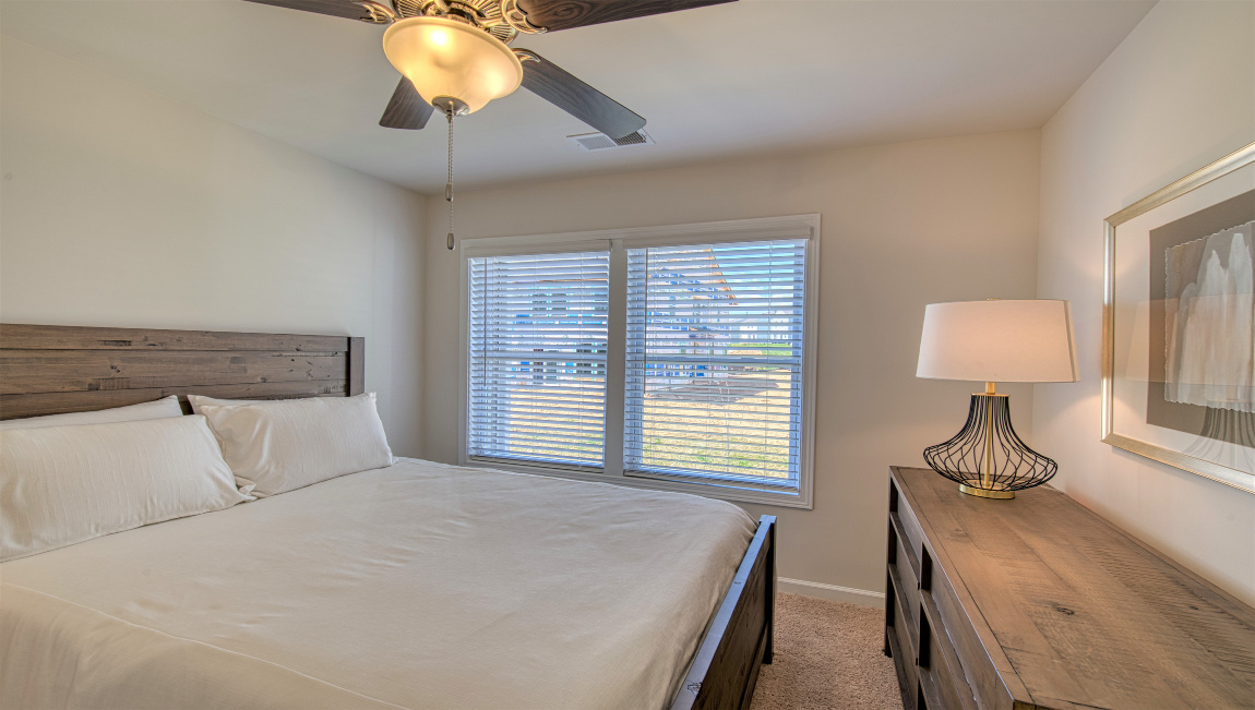 Carpeted bedroom with large window