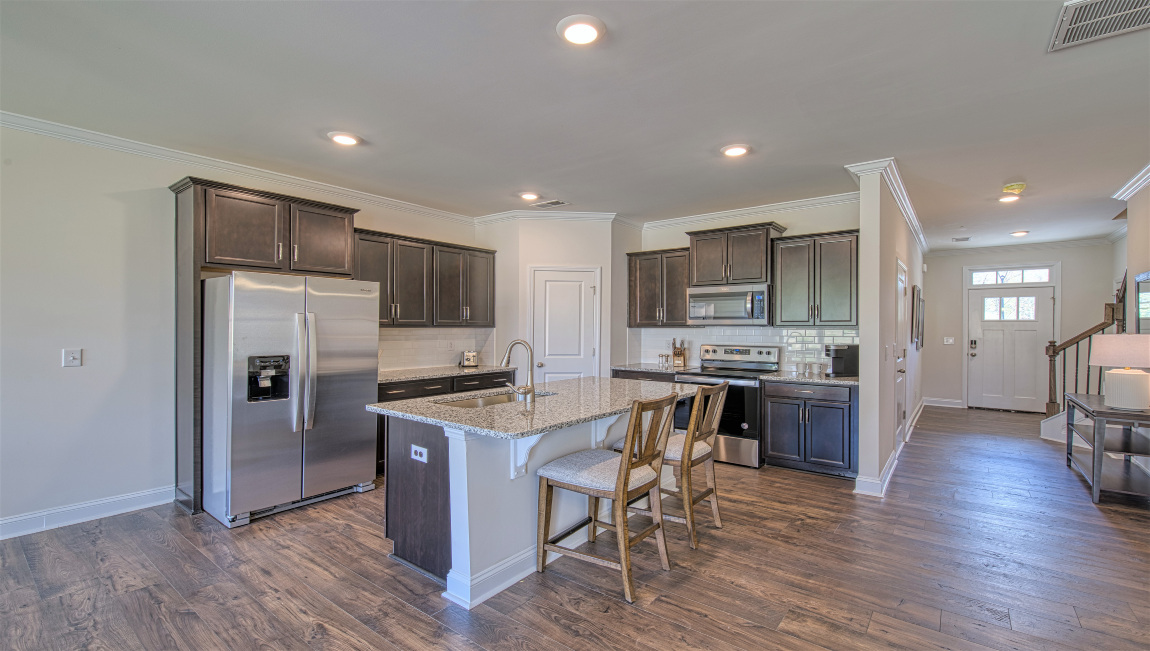 Open concept kitchen with island and stainless steel appliances