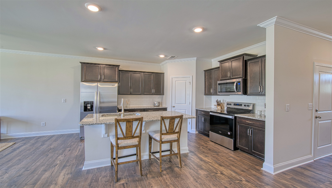 Open concept kitchen with island and stainless steel appliances