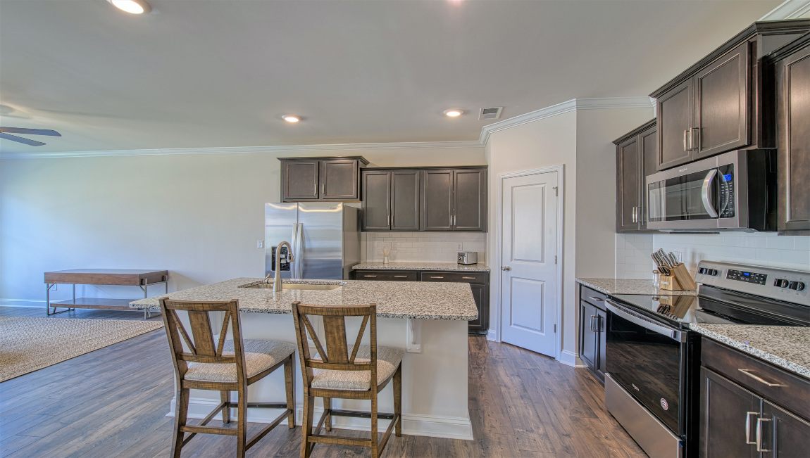 Open concept kitchen with island and stainless steel appliances