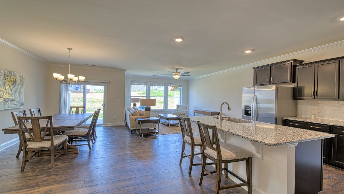 Open concept kitchen with island and stainless steel appliances