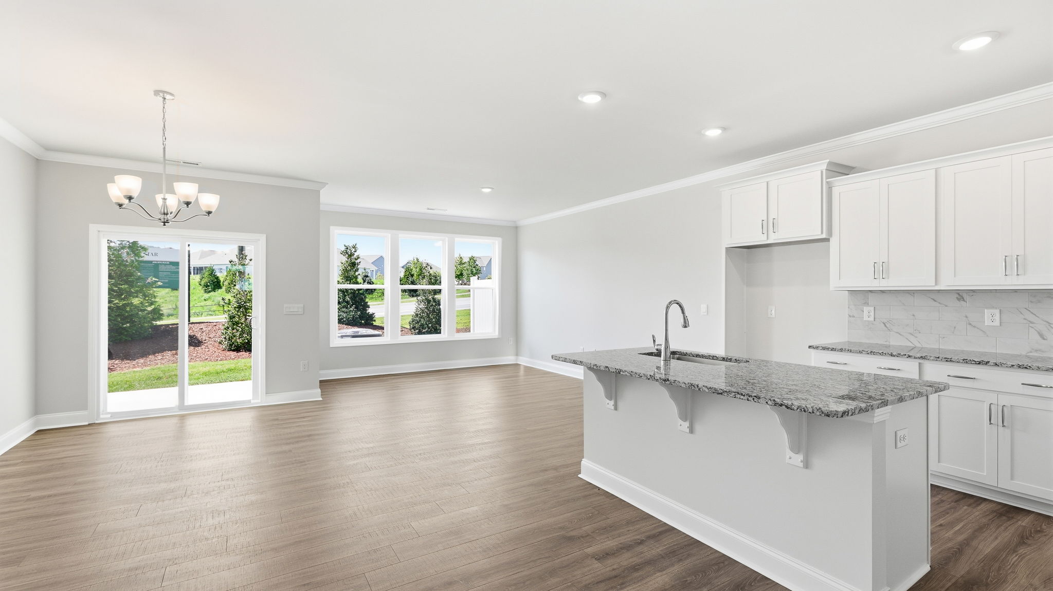 Open concept kitchen with large island and stainless steel appliances