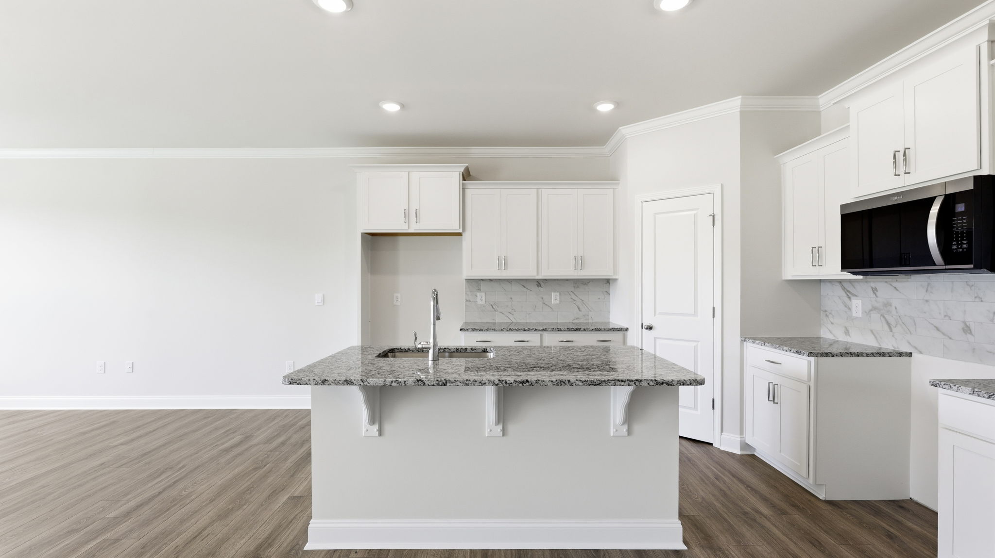 Open concept kitchen with large island and stainless steel appliances
