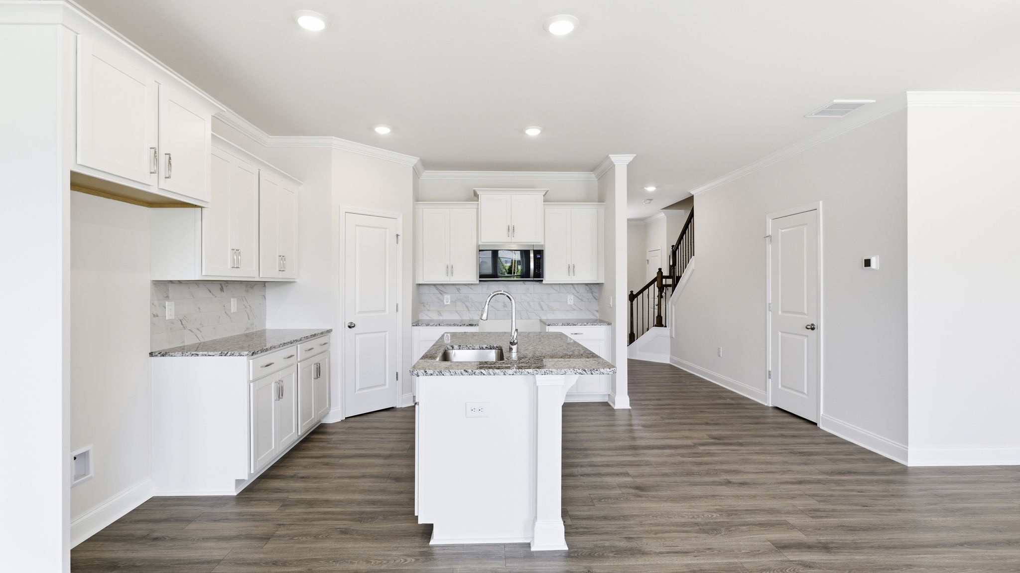 Open concept kitchen with large island and stainless steel appliances