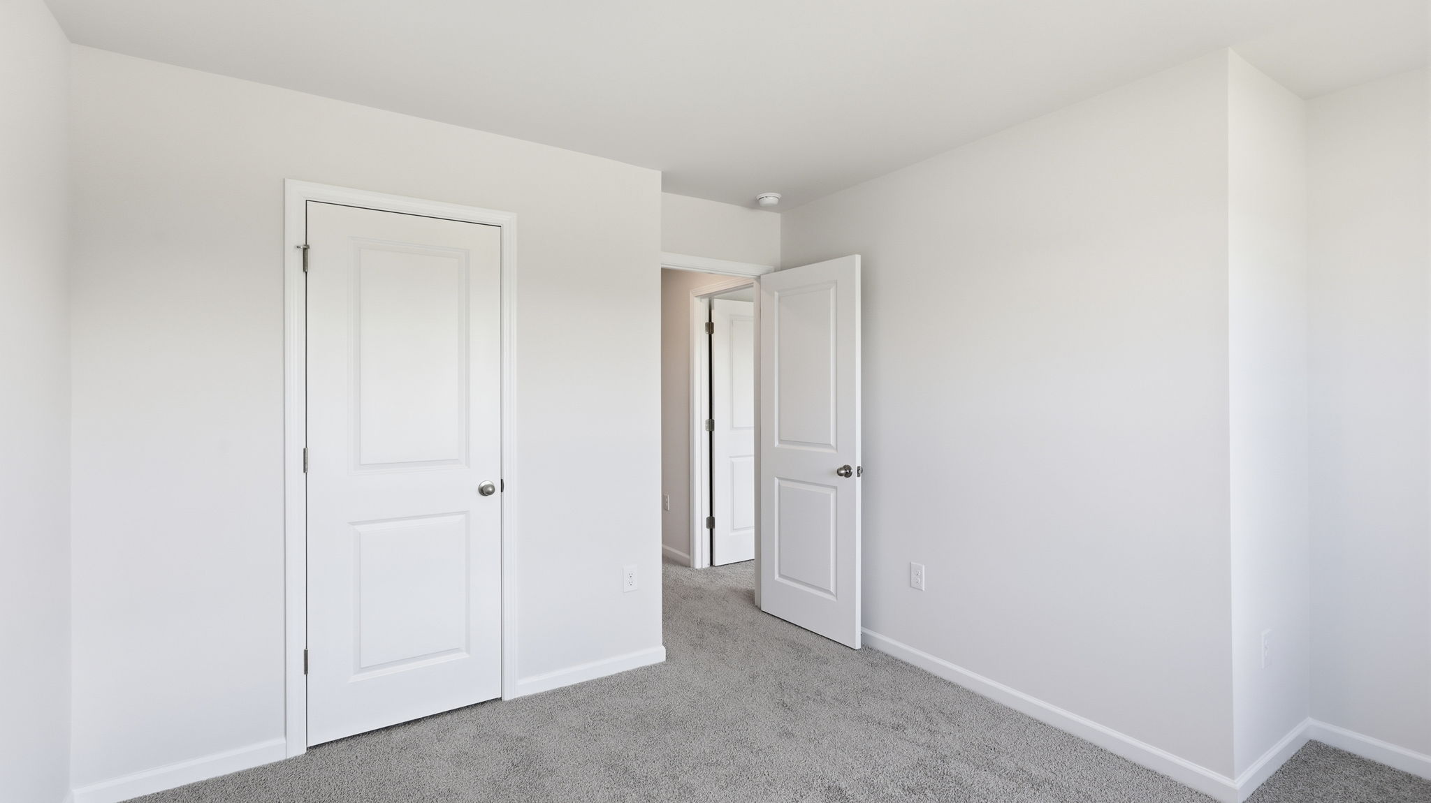 Bedroom with view of closet and hall