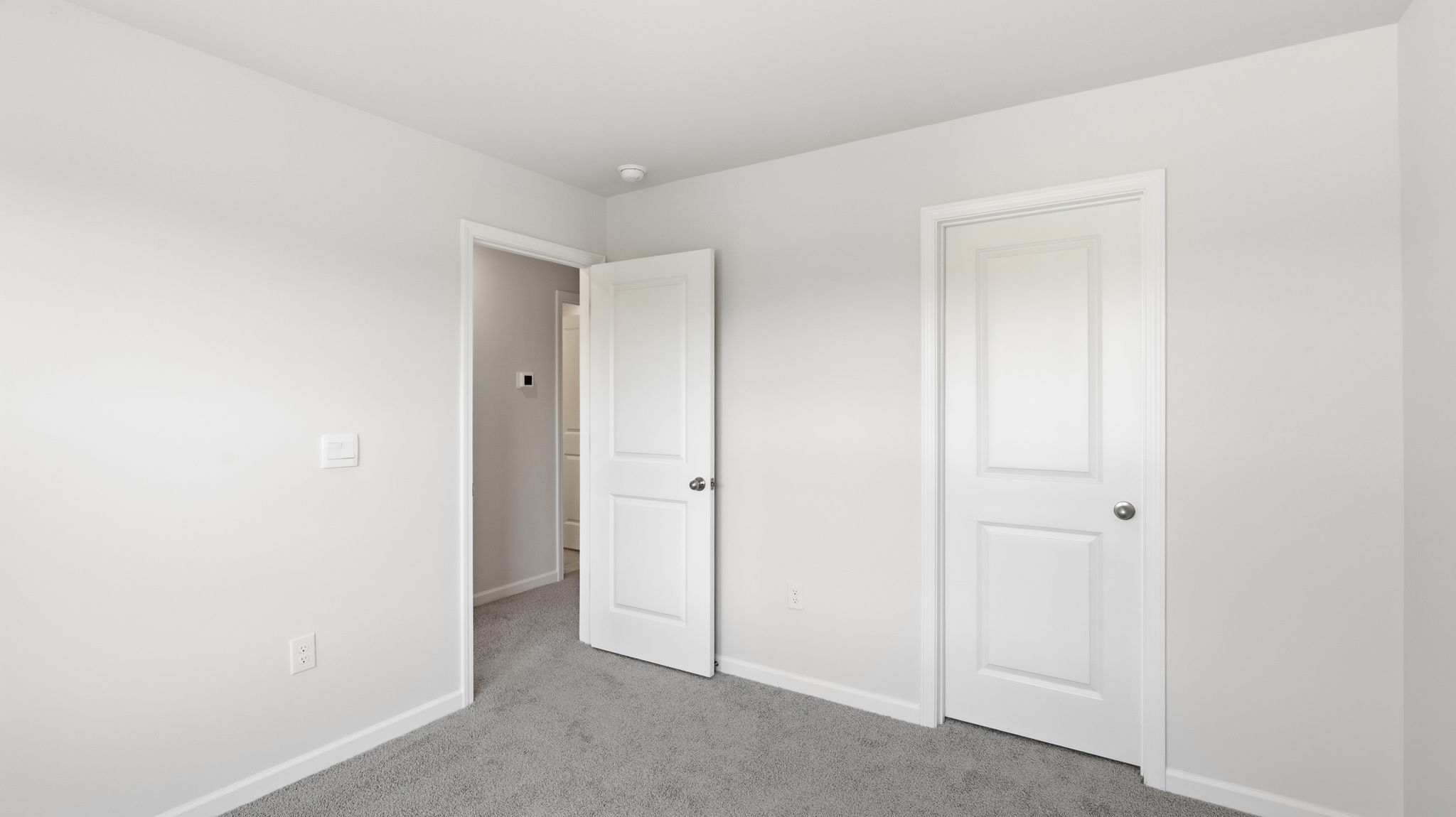 Bedroom with view of closet and hall