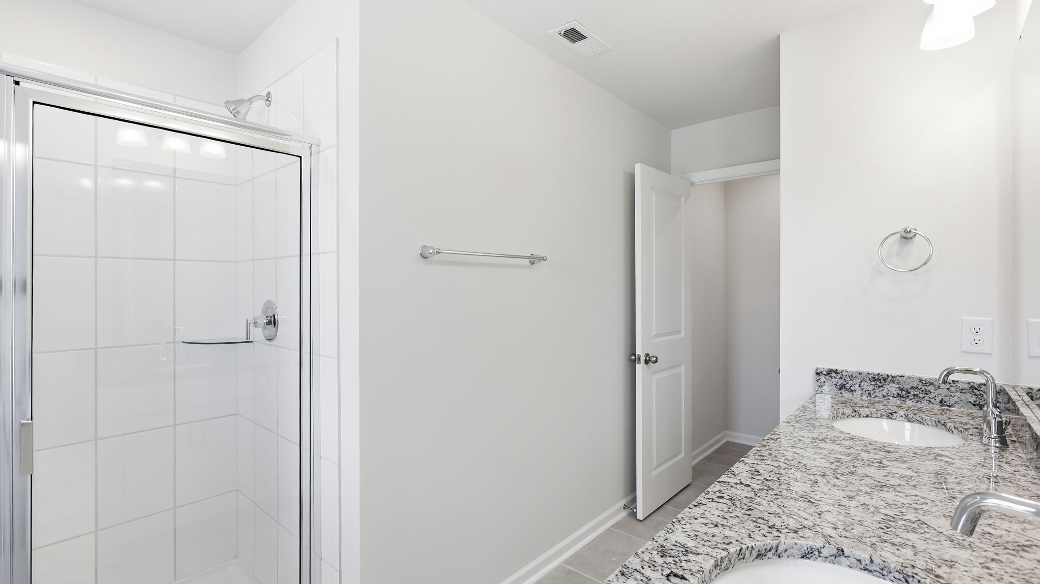 Primary bathroom with dual vanity and walk in shower