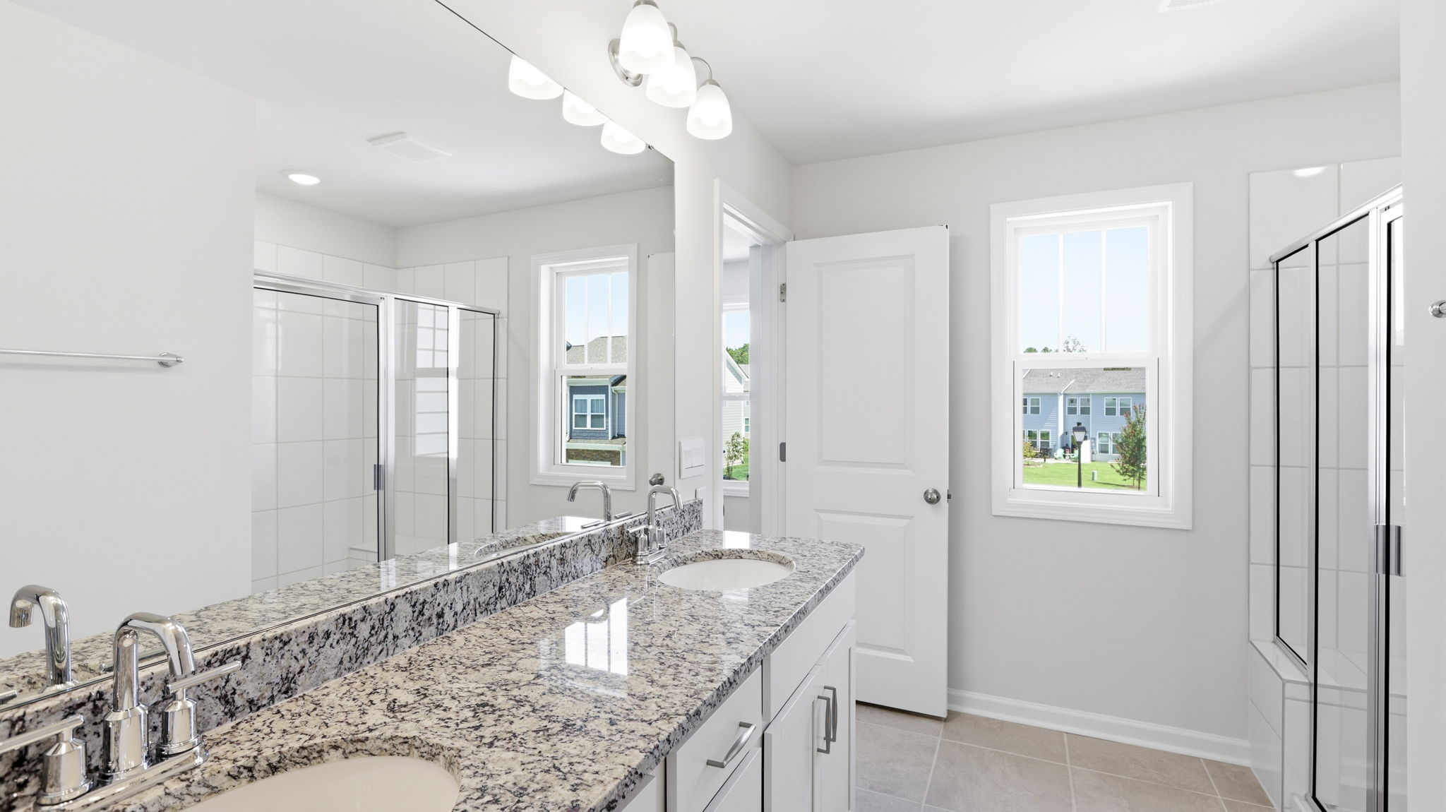 Primary bathroom with dual vanity and walk in shower
